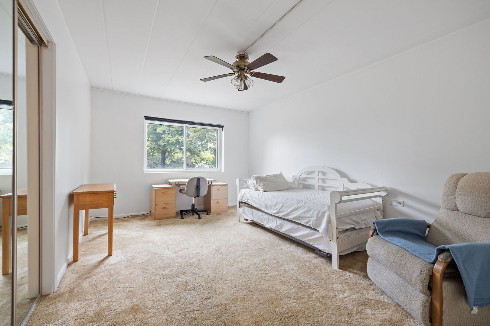 5540 Walnut Avenue, Unit 11B Downers Grove, IL 60515 - Photo 7 of 27 a bed room with a bed and a chair