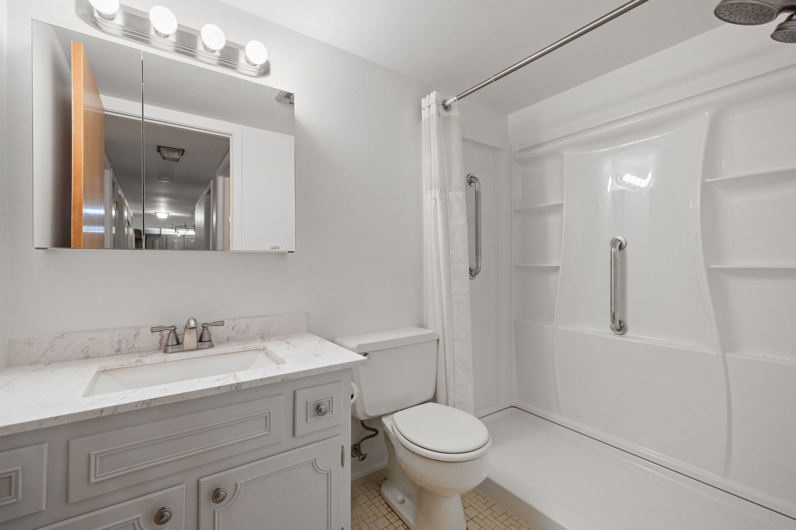 5540 Walnut Avenue, Unit 11B Downers Grove, IL 60515 - Photo 8 of 27 a bathroom with a sink a toilet and shower