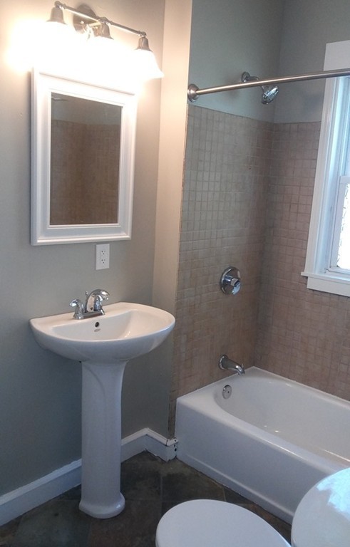 44 Lorenzo Street Springfield, MA 01109 - Photo 5 of 15 a bathroom with a sink and mirror with toilet