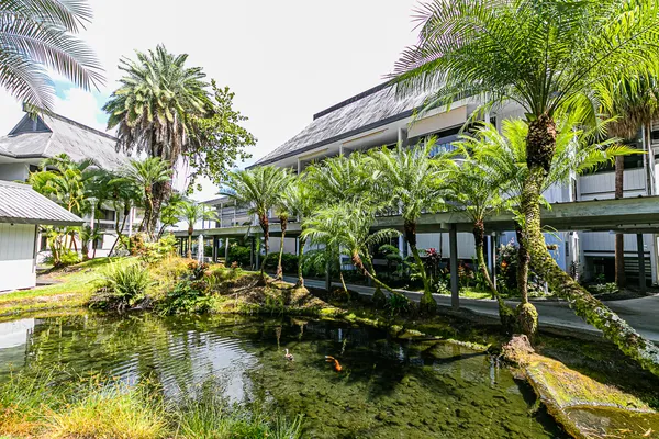 a view of house with yard and sitting area