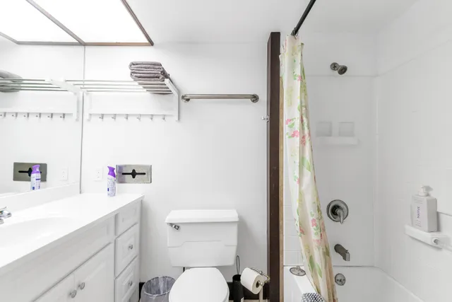 a bathroom with a sink a vanity and a shower