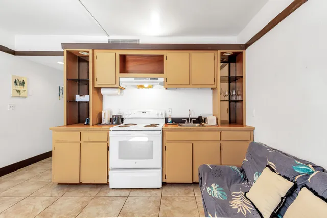 a kitchen with a stove top oven sink and cabinets