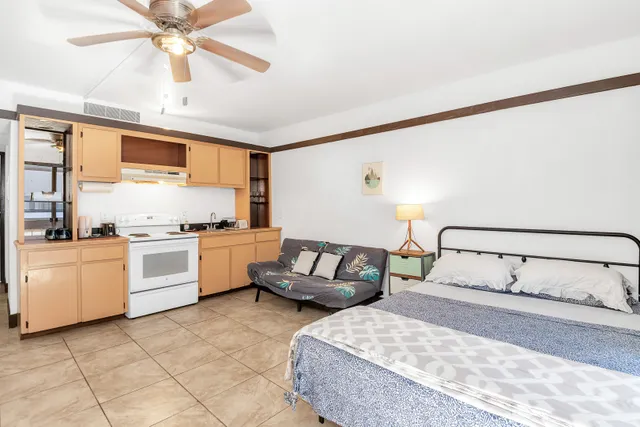 a bedroom with a bed and ceiling fan