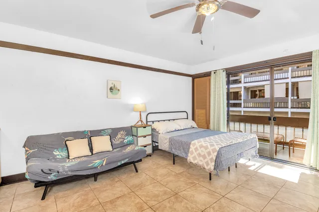 a bedroom with a bed a table and chair