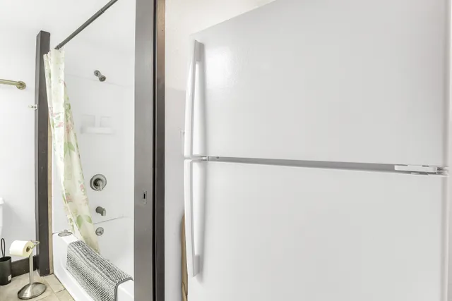 a bathroom with a glass shower door