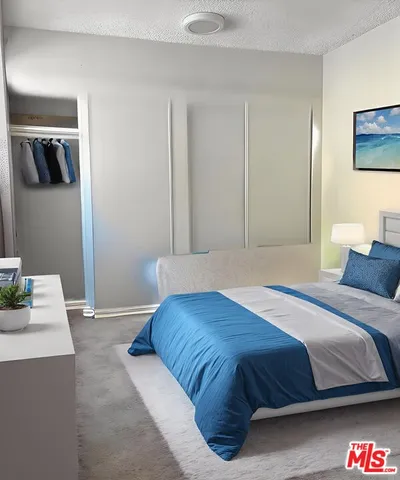 a bedroom with a bed and a lamp