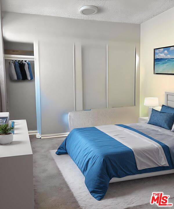 a bedroom with a bed and a lamp