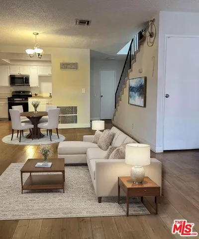 a living room with furniture and wooden floor
