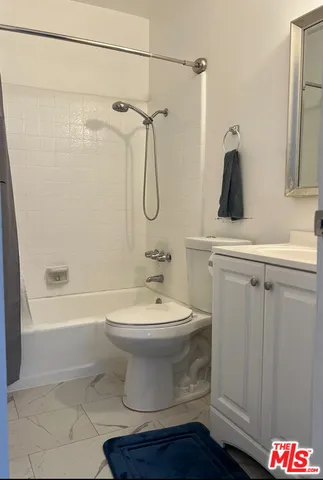 a bathroom with a toilet a sink and bathtub