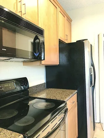 a kitchen with a stove and a refrigerator