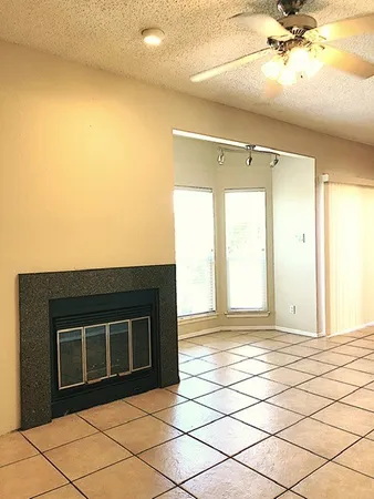 a view of empty room with kitchen and sink