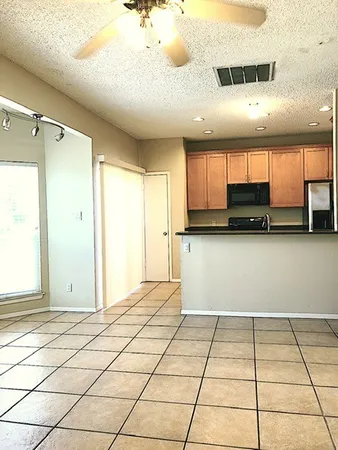 a view of a kitchen with a sink and cabinets