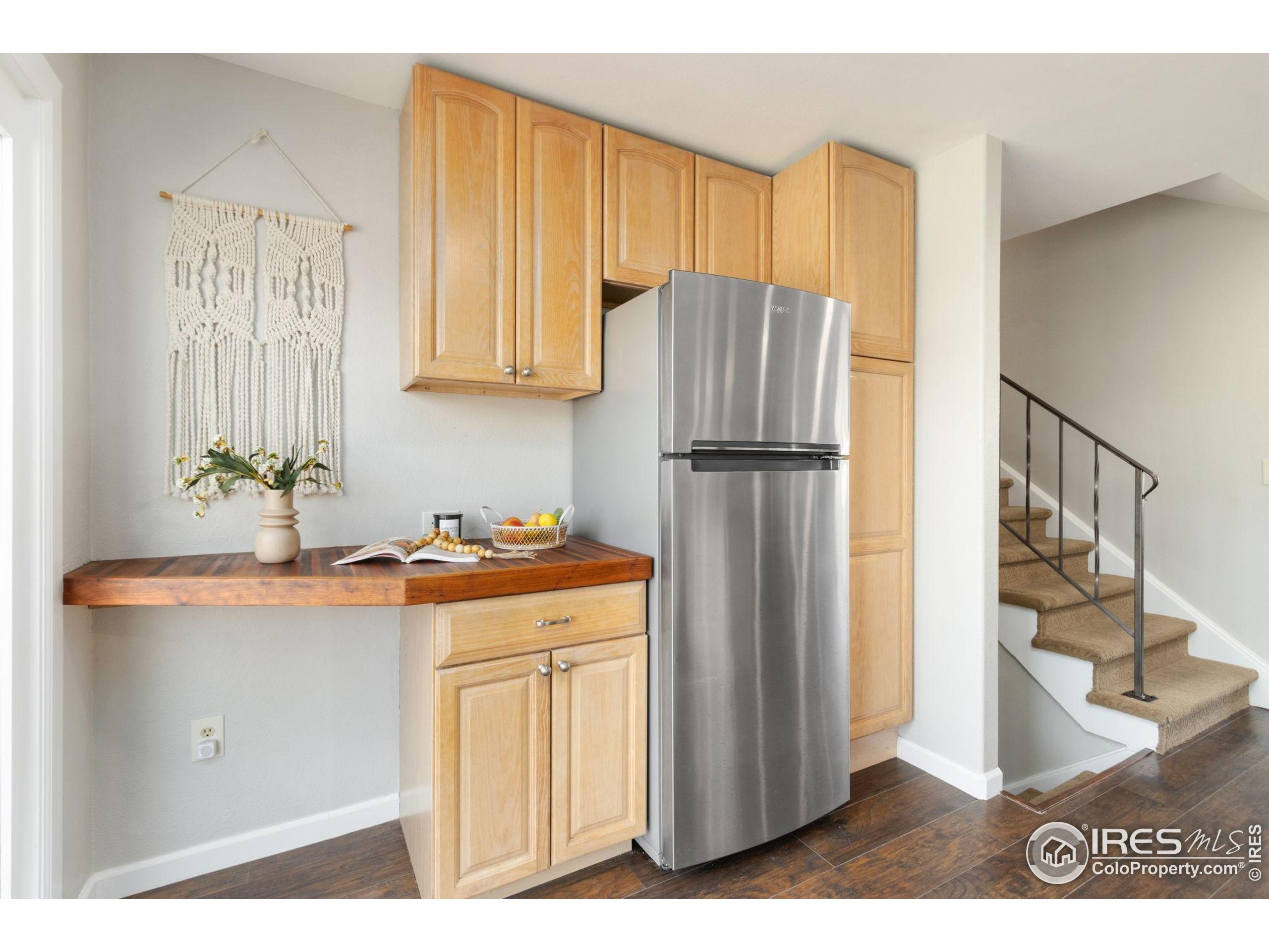 3024 Placer Court Fort Collins, CO 80526 - Photo 16 of 40 a kitchen with a refrigerator a stove a washer and dryer