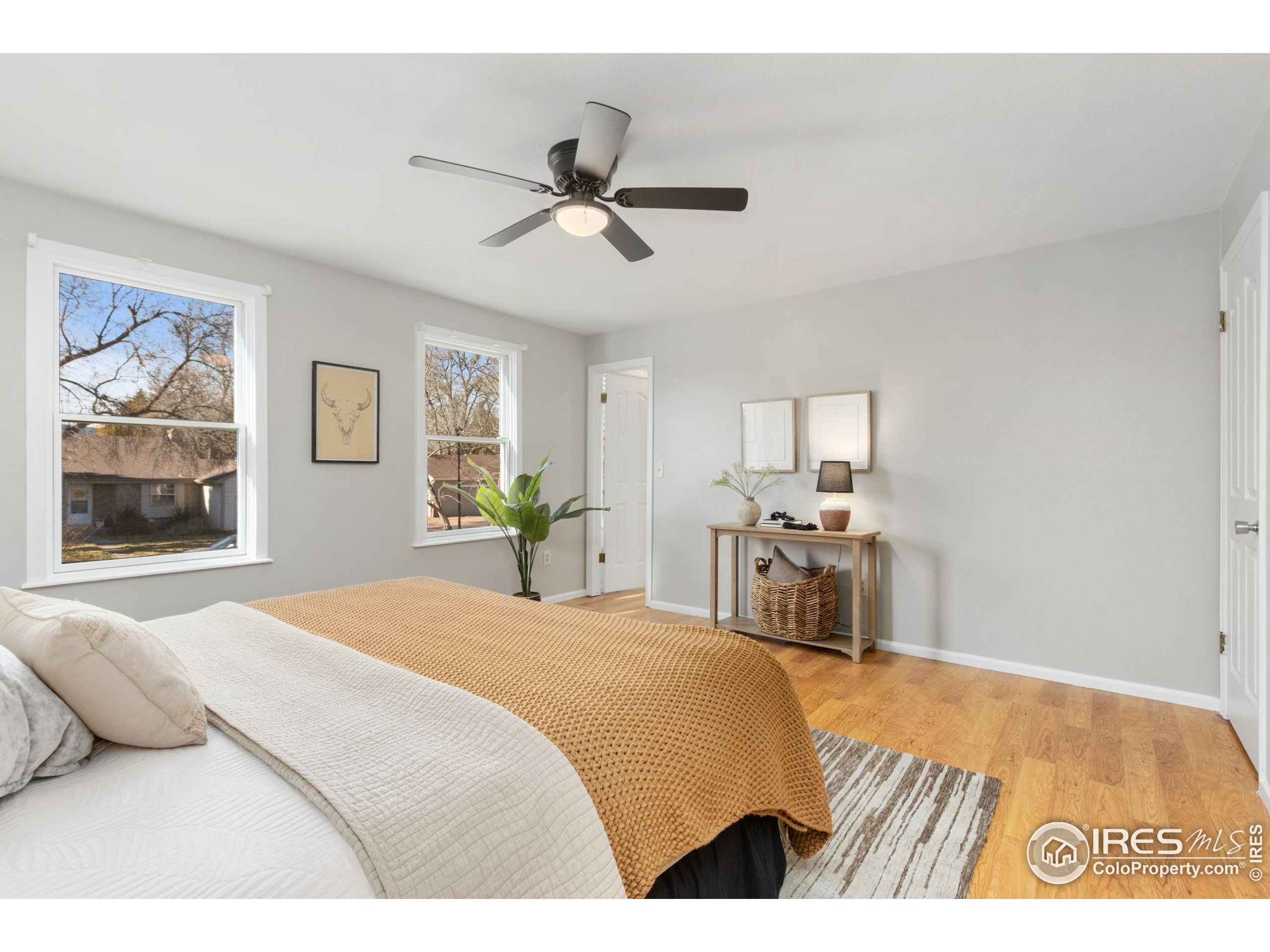 3024 Placer Court Fort Collins, CO 80526 - Photo 20 of 40 a bedroom with a bed and a chandelier
