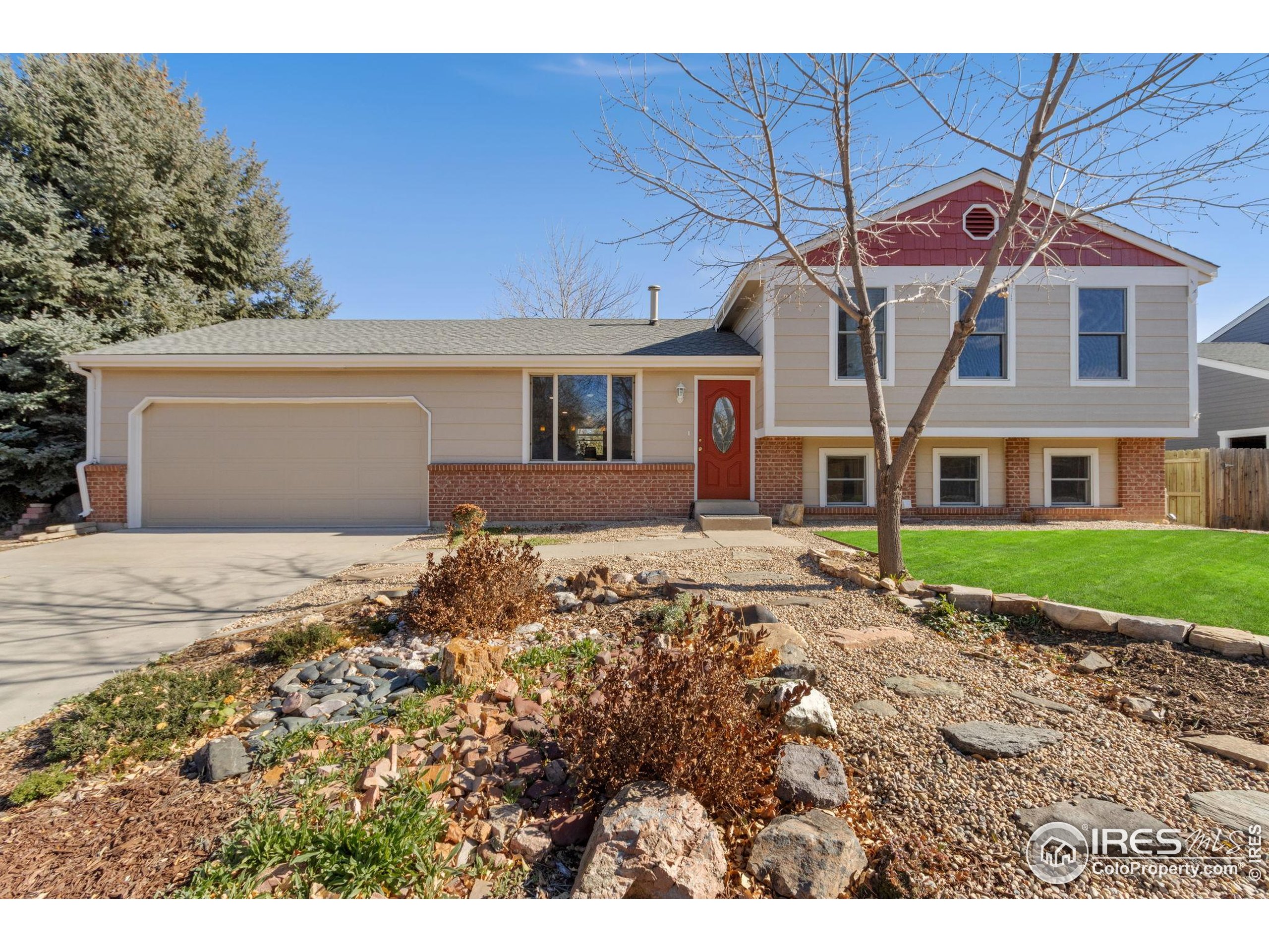 3024 Placer Court Fort Collins, CO 80526 - Photo 2 of 40 a front view of a house with a garden