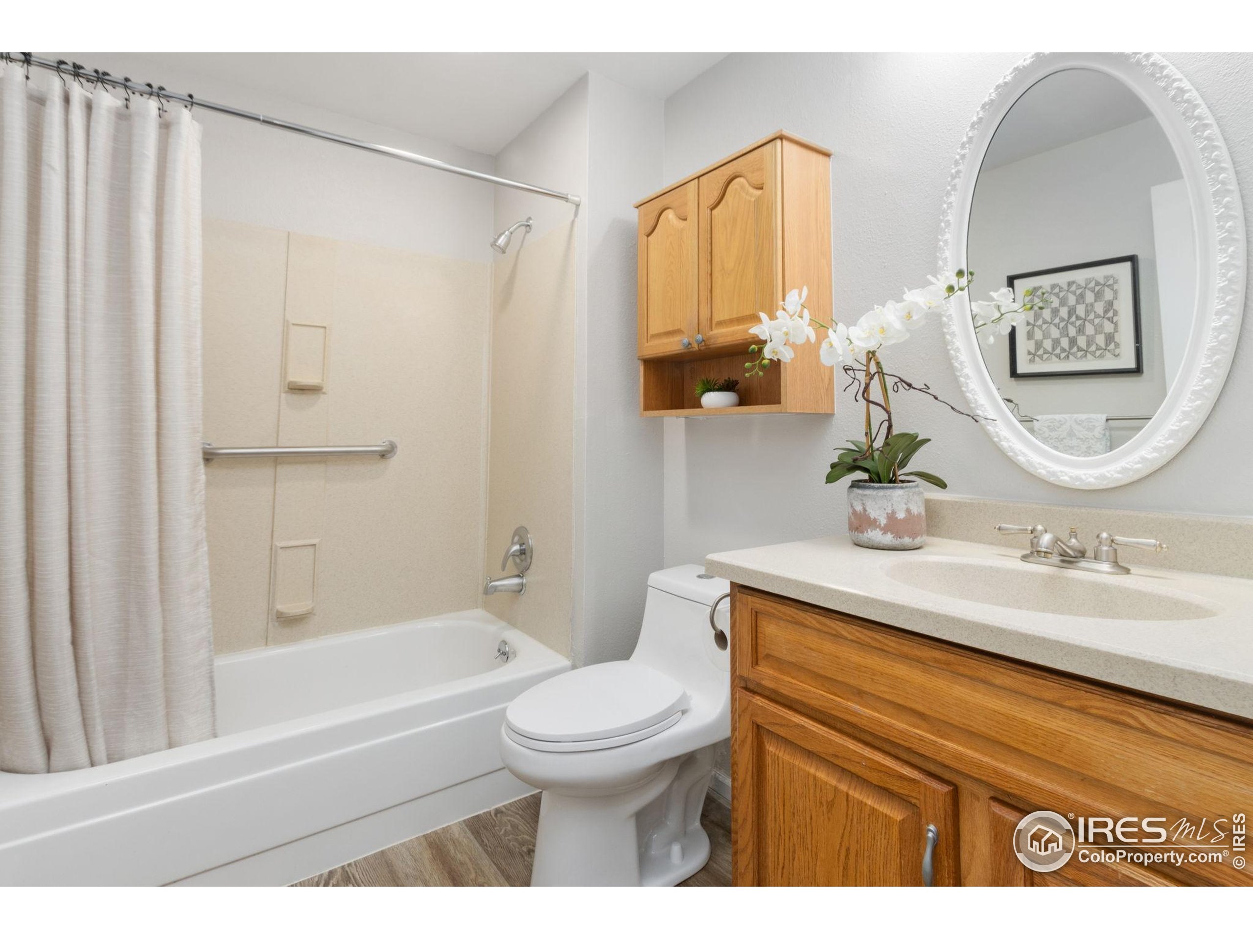3024 Placer Court Fort Collins, CO 80526 - Photo 22 of 40 a bathroom with a sink a toilet and a mirror