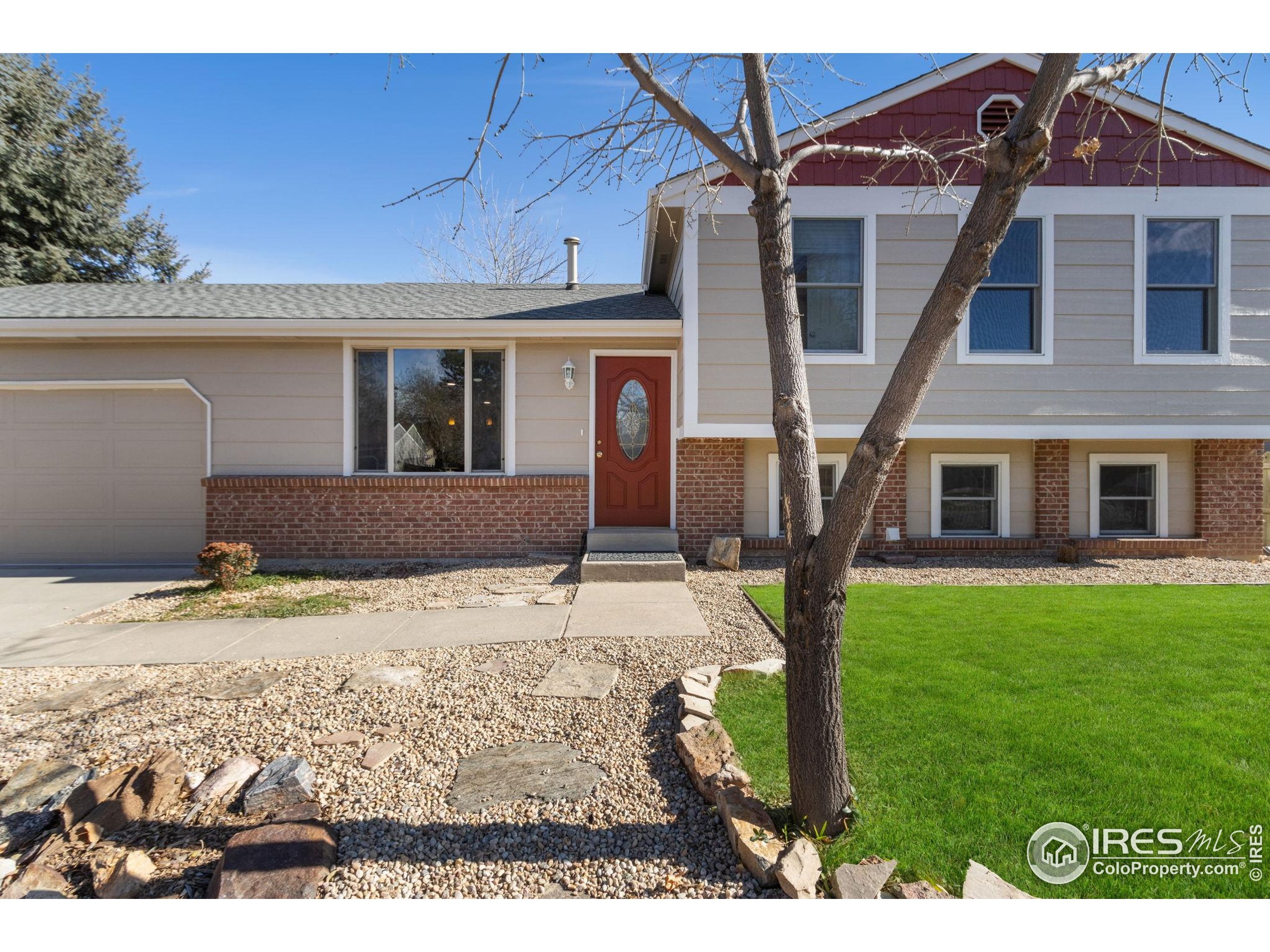 3024 Placer Court Fort Collins, CO 80526 - Photo 4 of 40 a front view of a house with garden