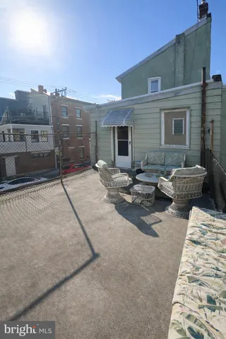 a backyard of a house with barbeque oven table and chairs