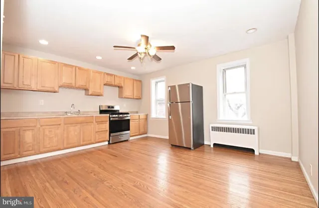 a kitchen with stainless steel appliances a refrigerator and a stove top oven
