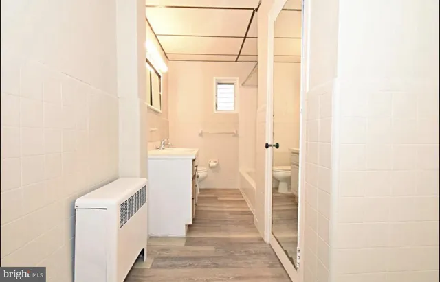 a bathroom with a sink a toilet and a shower