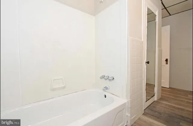 a bathroom with a bathtub and shower
