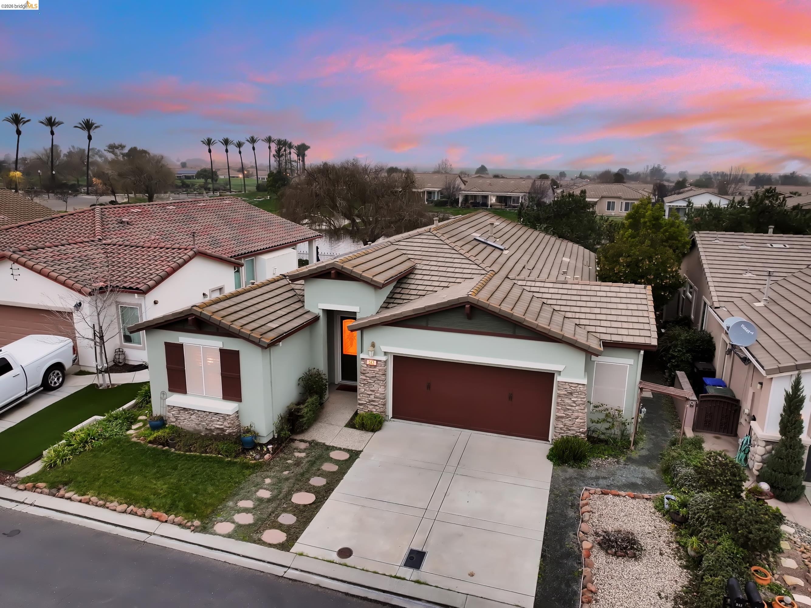 342 Desert Forest Court Rio Vista, CA 94571 - Photo 3 of 40 View of front of property with an attached garage, stucco siding, stone siding, driveway, and a tile roof