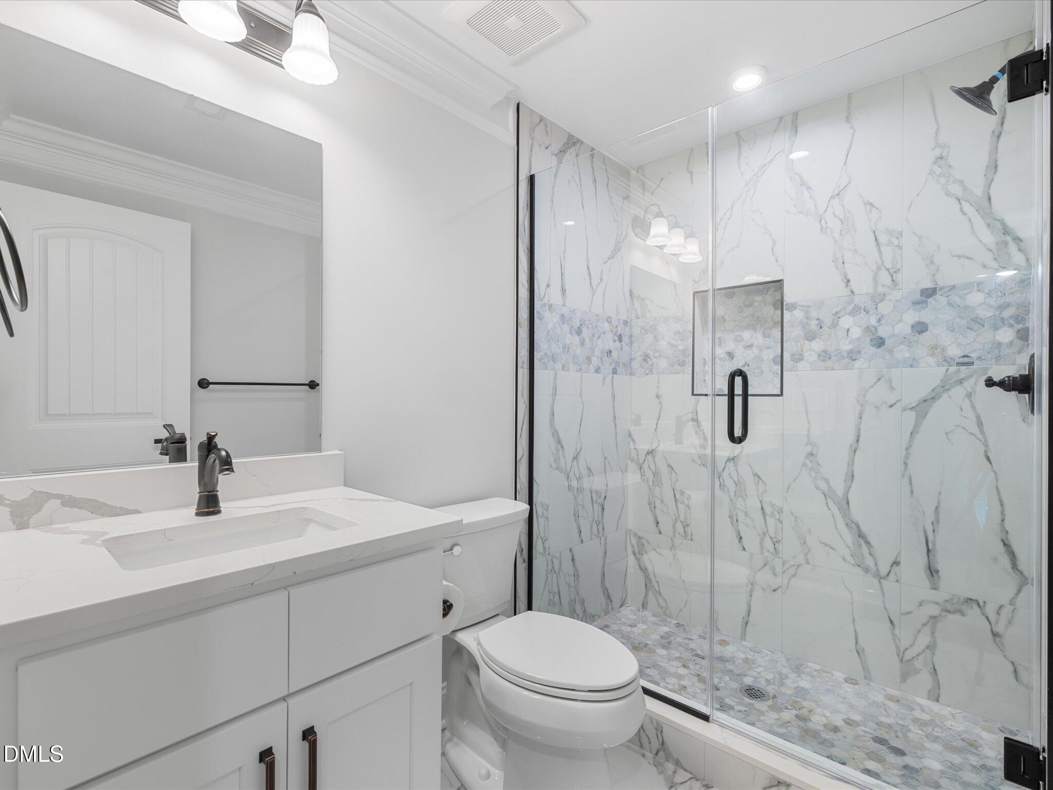 316 Howland Avenue Cary, NC 27513 - Photo 12 of 34 a bathroom with a sink toilet vanity and shower