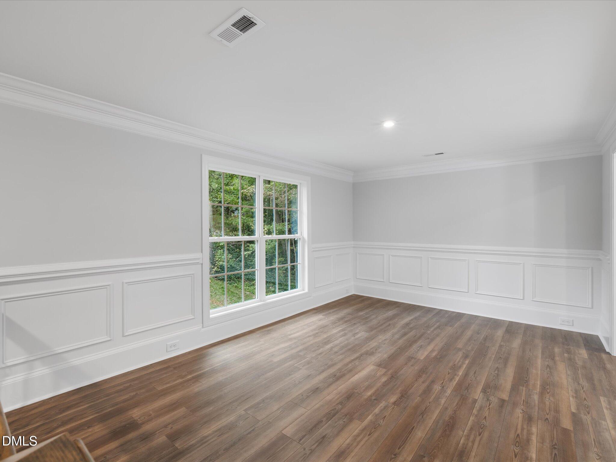 316 Howland Avenue Cary, NC 27513 - Photo 13 of 34 a view of an empty room with wooden floor and a window