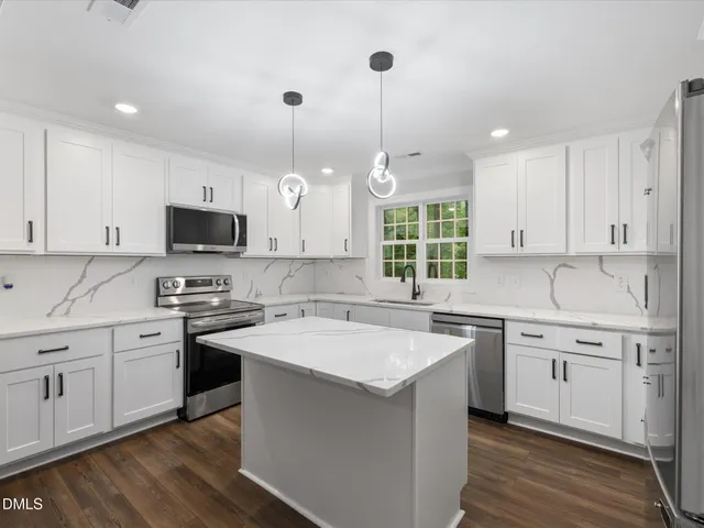 a kitchen with a sink stove and white cabinets