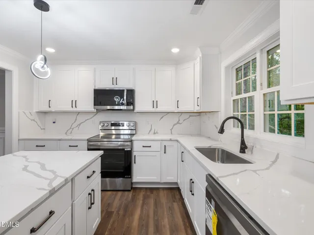 a kitchen with a sink stove and cabinets