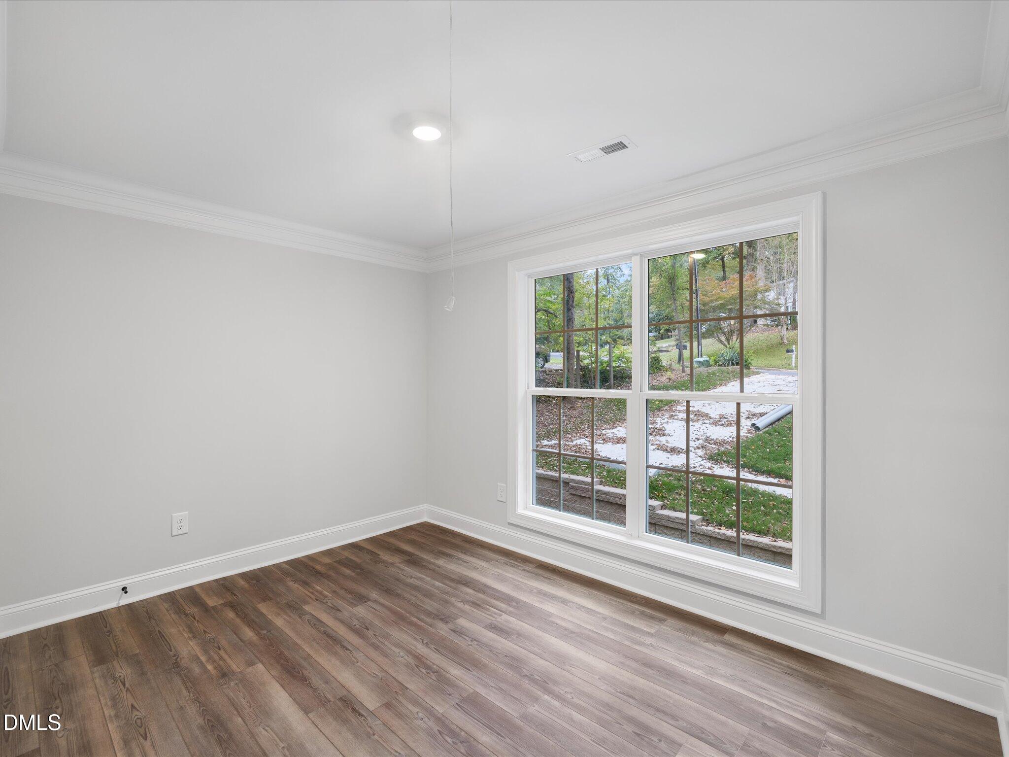 316 Howland Avenue Cary, NC 27513 - Photo 10 of 34 a view of wooden floor and windows in a room
