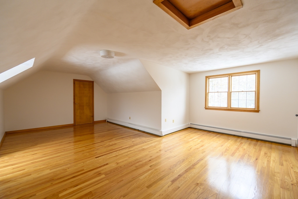 208 Rolling Ridge Road Amherst, MA 01002 - Photo 20 of 40 an empty room with wooden floor and windows
