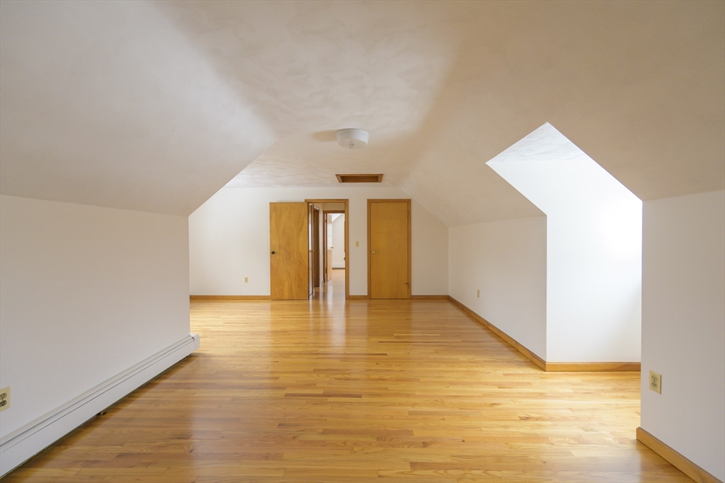208 Rolling Ridge Road Amherst, MA 01002 - Photo 21 of 40 a view of an empty room and window with wooden floor