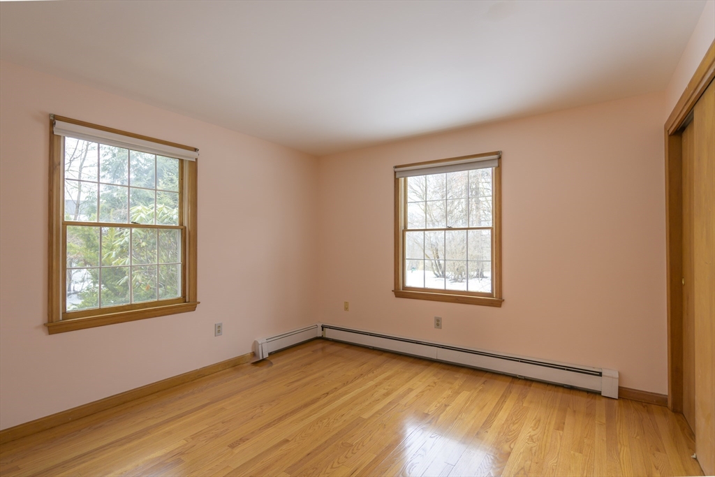 208 Rolling Ridge Road Amherst, MA 01002 - Photo 28 of 40 a view of an empty room with wooden floor and a window