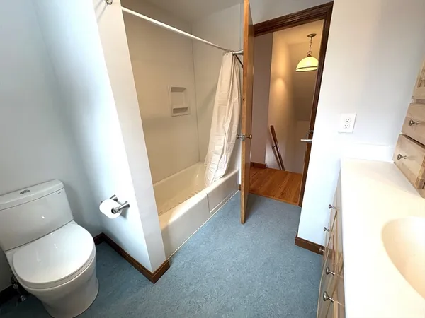 a bathroom with a toilet and a tub