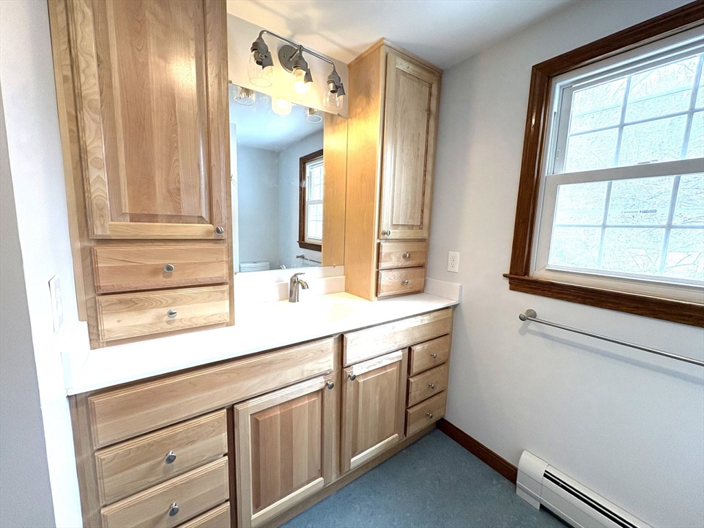 208 Rolling Ridge Road Amherst, MA 01002 - Photo 35 of 40 a bathroom with a sink a mirror and a window