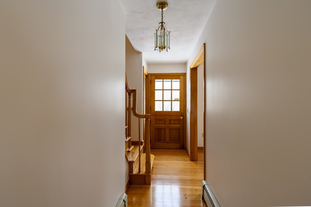 208 Rolling Ridge Road Amherst, MA 01002 - Photo 4 of 40 a hallway with a view of bedroom and wooden floor