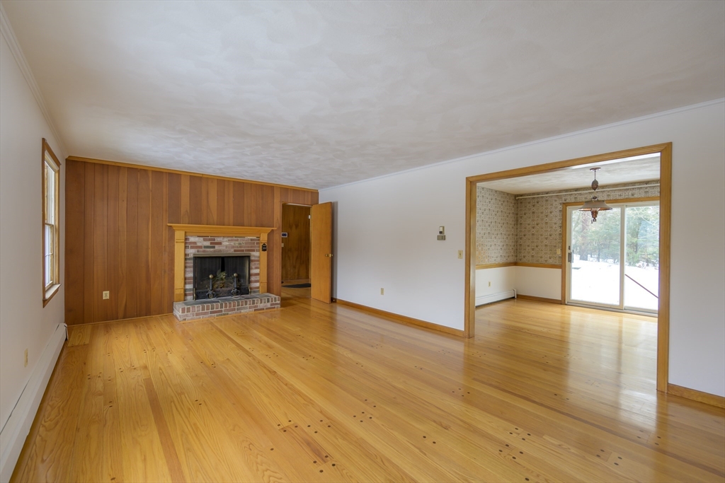 208 Rolling Ridge Road Amherst, MA 01002 - Photo 6 of 40 a view of an empty room with a fireplace and a window