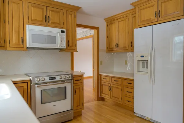 a kitchen with stainless steel appliances granite countertop a stove a microwave and a refrigerator