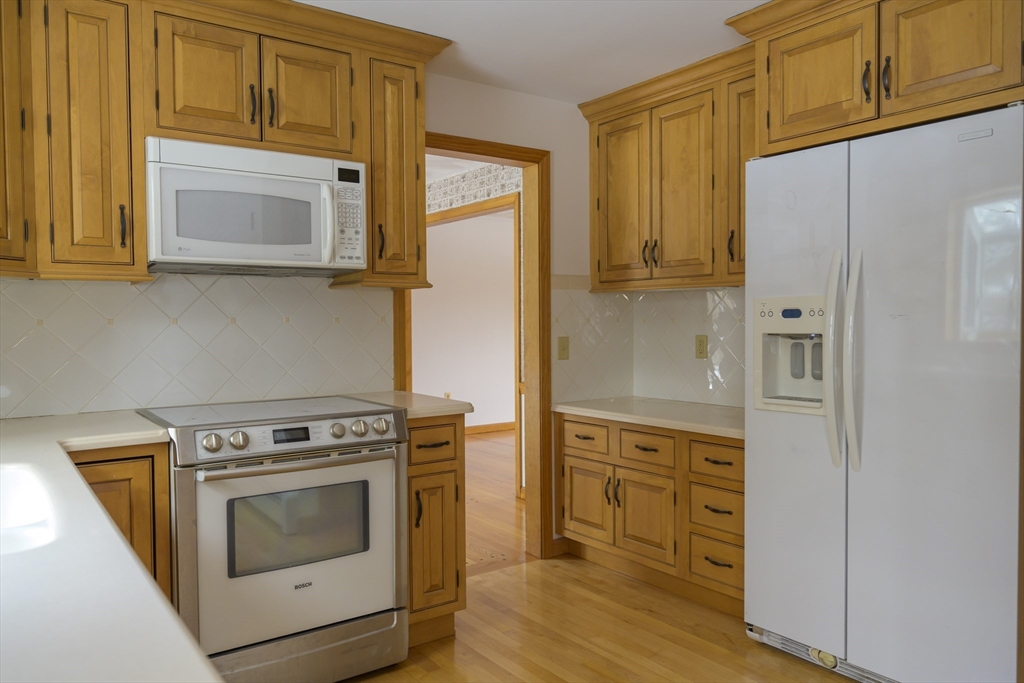 208 Rolling Ridge Road Amherst, MA 01002 - Photo 8 of 40 a kitchen with stainless steel appliances granite countertop a stove a microwave and a refrigerator