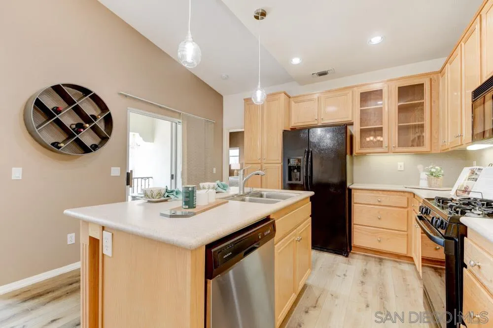 11650 Miro Circle San Diego, CA 92131 - Photo 11 of 28 a kitchen with stainless steel appliances granite countertop a sink stove and refrigerator