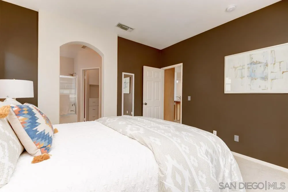 11650 Miro Circle San Diego, CA 92131 - Photo 16 of 28 a bedroom with a bed and a lamp