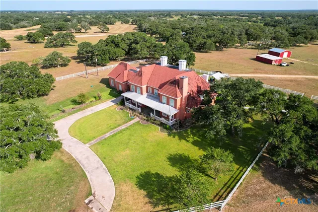 an aerial view of a house with pool ocean view