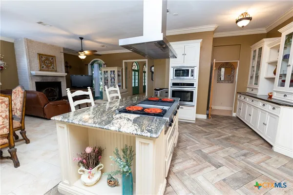a living room with furniture flat screen tv and a fireplace