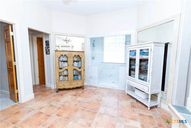 a bathroom with a toilet and a shower curtain