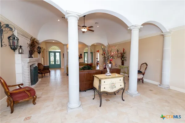 a living room with furniture gym equipment and mirrors