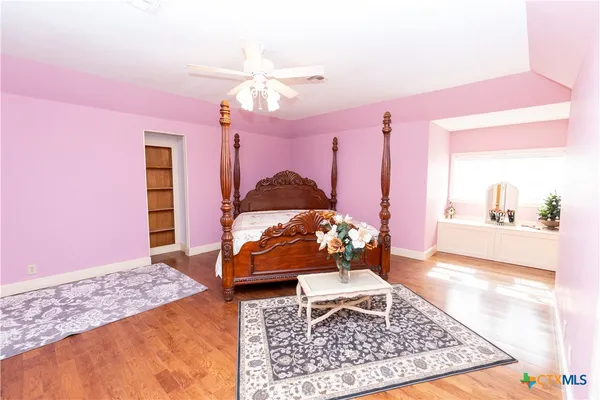 a living room with furniture a rug and gym equipment