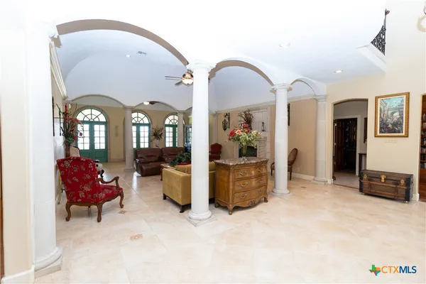a view of a dining room with furniture and chandelier