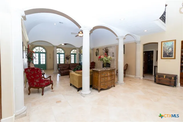 a view of a dining room with furniture and chandelier