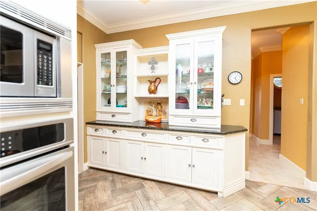 a kitchen with stainless steel appliances a refrigerator and cabinets
